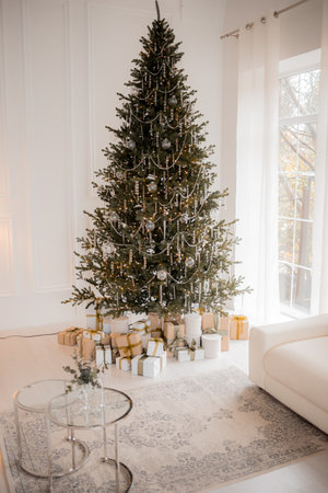 Domestic and cozy christmas living room interior with corduroy sofa, white shelf, mock up poster frame, christmas tree, decoration, wreath, gifts and accessories. Home decor. Family time. Template.の写真素材