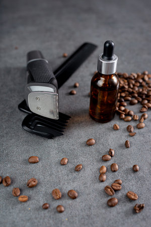 Man beard grooming items on a stone table surface, comb, oil and electric trimmerの写真素材