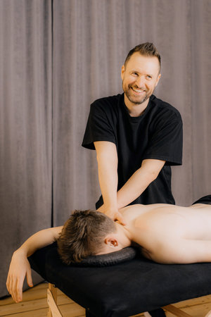 Modern rehabilitation physiotherapy worker with client