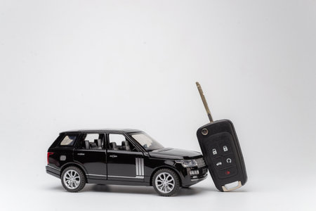Toy car with a key on white backgroundの写真素材