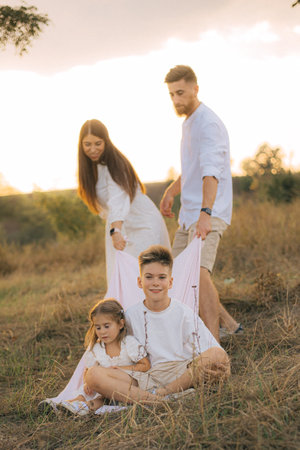 Parents, kids and happy family in park, garden and sunshine field outdoors for bonding, love and...