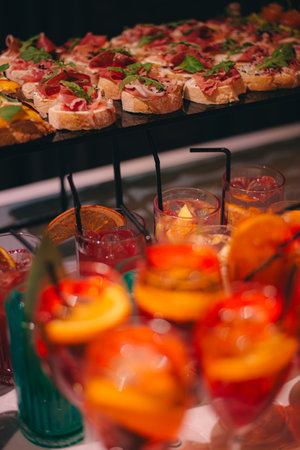 catering buffet table with snacks and appetizers. Set of canapes with jamon, bruschetta, pear and cheeseの写真素材