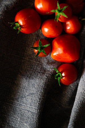 Red tomatoes on grey kitchen towelの写真素材