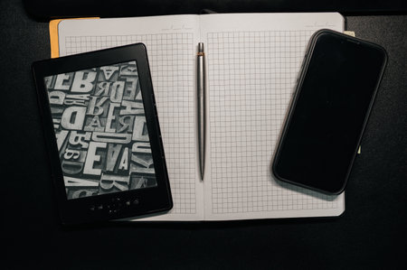 An Open Notebook accompanied by a Pen set on a Dark Desk inviting creativity and productivity