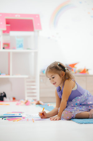 A Creative Child Engaged in a Fun and Colorful Coloring Activity in the Playroom Environmentの写真素材