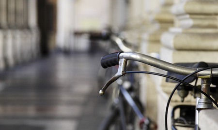 Bicycle handlebar over blurred avenueの写真素材