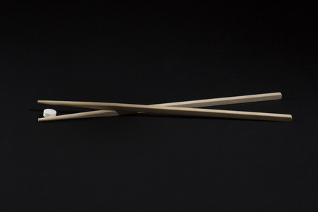 Chinese chopsticks for food with tablet Doctor on a black backgroundの写真素材