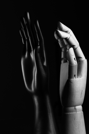 Black hand exhibitor and wooden hand model symbol of friendshipの写真素材