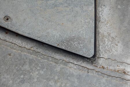 Manhole metal background with rust and nailの写真素材