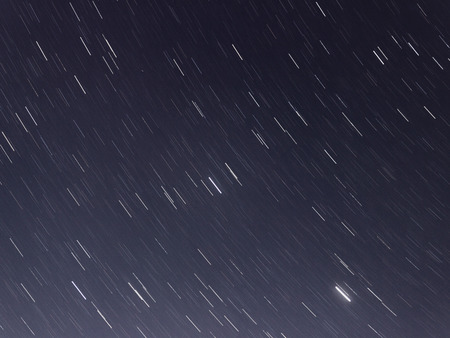 Stars movement over the sky captured with slow shutter speed.の写真素材