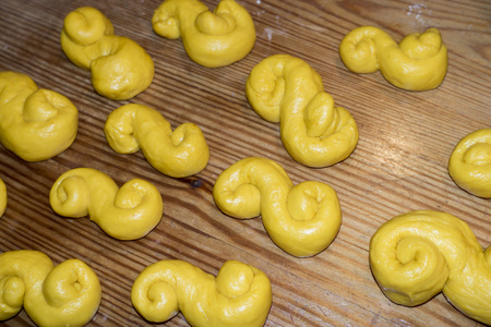 Yellow Lucia saffron buns ready for the ovenの写真素材