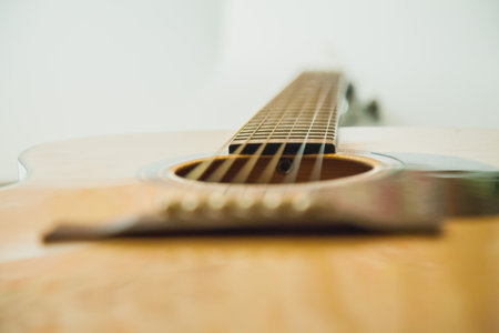 Classical guitar with vibrating strings on a white background the strings and fretboard of the...