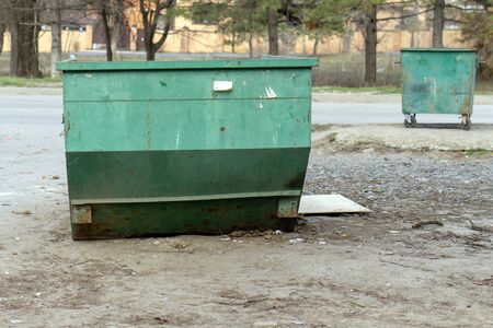 container for the collection and transportation of green garbage on the background of road and vegetationの写真素材