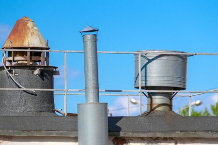tin pipes on a roof covered with roofing material