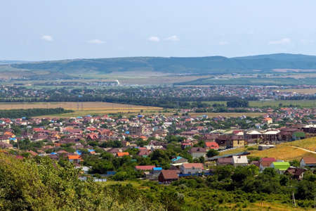 View from the mountain to a small town with colorful housesの写真素材