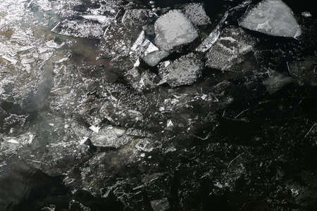 Texture. Broken ice on dark water. Above the glare of the bright sun. The dark key.