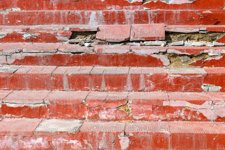 Ruined staircase made of red tiles. After the snow melts. Bad cement. Poor quality work of builders.
