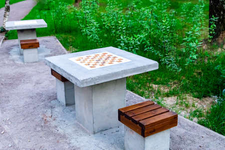 A table and chairs made of concrete. A chessboard is drawn on the line. park. Intellectual leisure for people.の写真素材