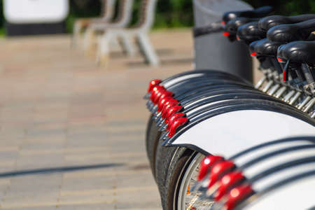A number of bikes for rent rear wheels with red cataphotes. Outdoor. Spotr. Transport.の写真素材