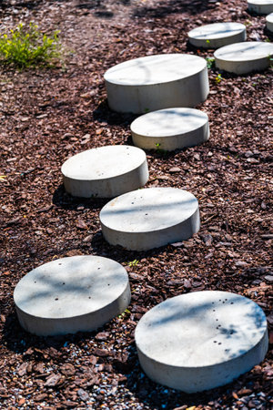 Decorative path of round concrete blocks in the park.