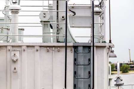Ship's ladder to the upper deck on a small vessel of white color