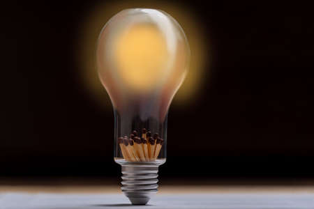 The concept of replacing electricity with wooden fuel. Light bulb in which matches instead of...