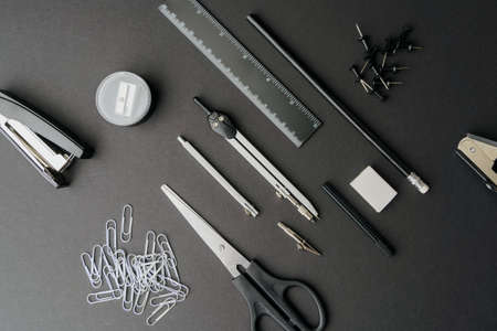 Various stationery on a dark background. Diagonal composition. Black and white.の写真素材