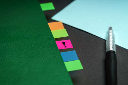 The concept is a very important note. Planner in the form of a notebook with multi-colored labels. Exclamation pointの写真素材