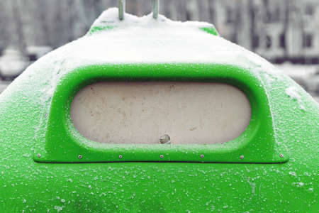 Green garbage can with vertical lid for separate garbage collection. The neck of the bottle sticks outの写真素材