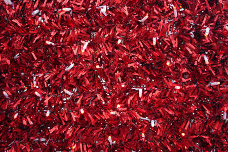 Texture. Red ribbon texture made of synthetic ribbon with light bulbs.