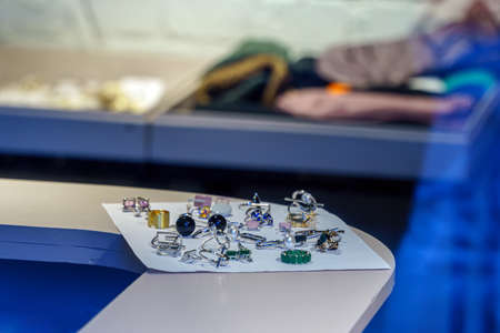 Womens jewelry lies on a sheet of paper on the counter