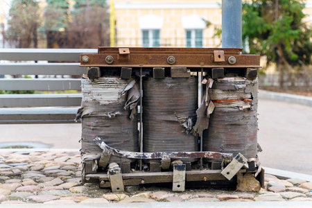 Large old coils in the form of a block with a copper winding from an electrical transformer.