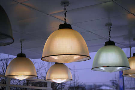 Lampshades on yellow and green lamps. Outside
