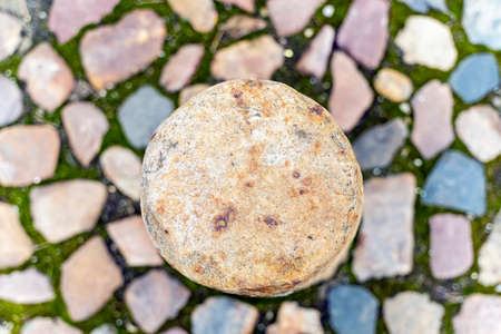 texture. Round gray stone in the center. Blurred background of different stones.の写真素材