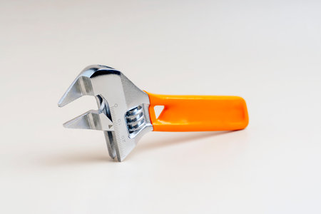 Small adjustable wrench with orange handle and size divisions.の写真素材