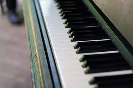 Keys of a very old piano with a cracked coating of dark color.