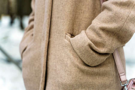 Hands in pockets of coats of bezel color made of woolの写真素材
