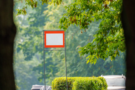 Plate with white lettering field and red border surrounded by greeneryの写真素材