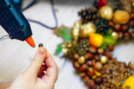 Making Christmas decorations from nuts with the help of a glue gunの写真素材