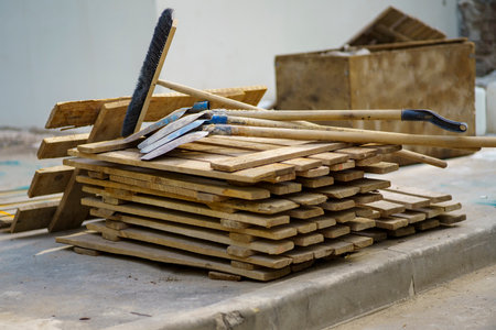 The concept of quitting. Shovels and brushes thrown on wooden decksの写真素材