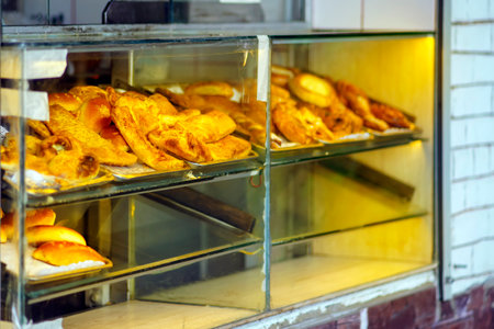 Street pastries on a dirty glass counterの写真素材