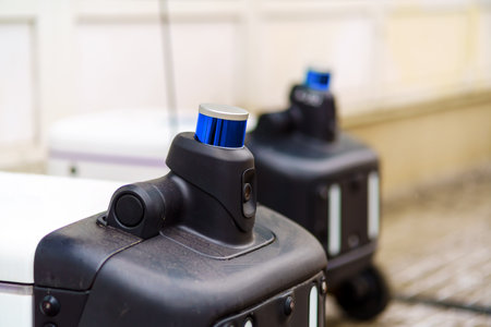 Robot couriers with cameras and lidar stand in a row on the streetの写真素材