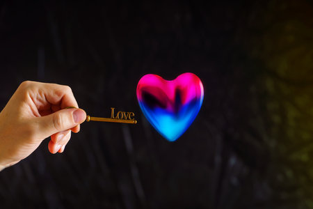 The key with the inscription love is trying to open the heart. The concept of the discovery of love.の写真素材