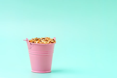 A small pink bucket with cereal rodent foodの写真素材