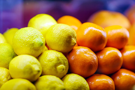 Lemons and oranges lie in a heap evenlyの写真素材