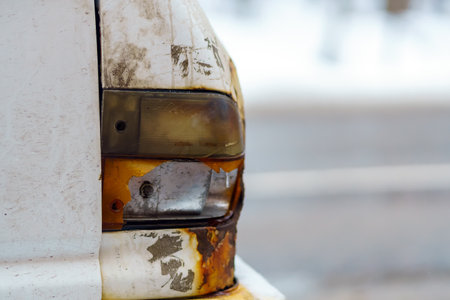 Broken turn signal to the right of the old carの写真素材