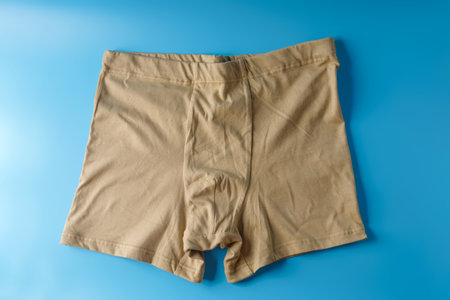 Big mens beige underpants on a blue backgroundの写真素材