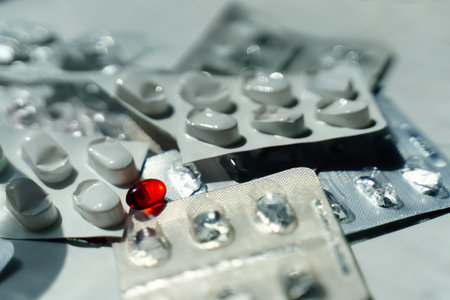 One last red pill lies among the empty pill blistersの写真素材