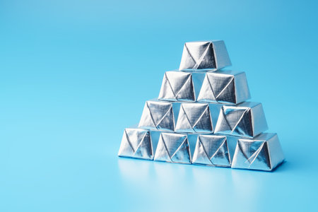 Sweets in a silver wrapper in the shape of a pyramid on a blue background