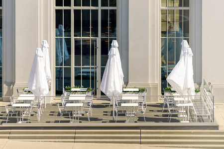 The street restaurant is decorated in white tones on a bright dayの写真素材